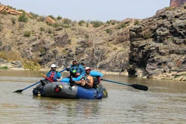 a man riding on the back of a boat in a body of water